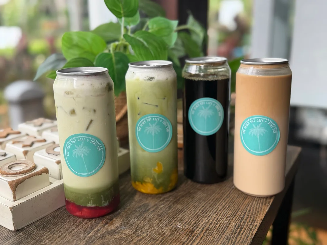 Four colourful iced drinks with The Beach Hut branding