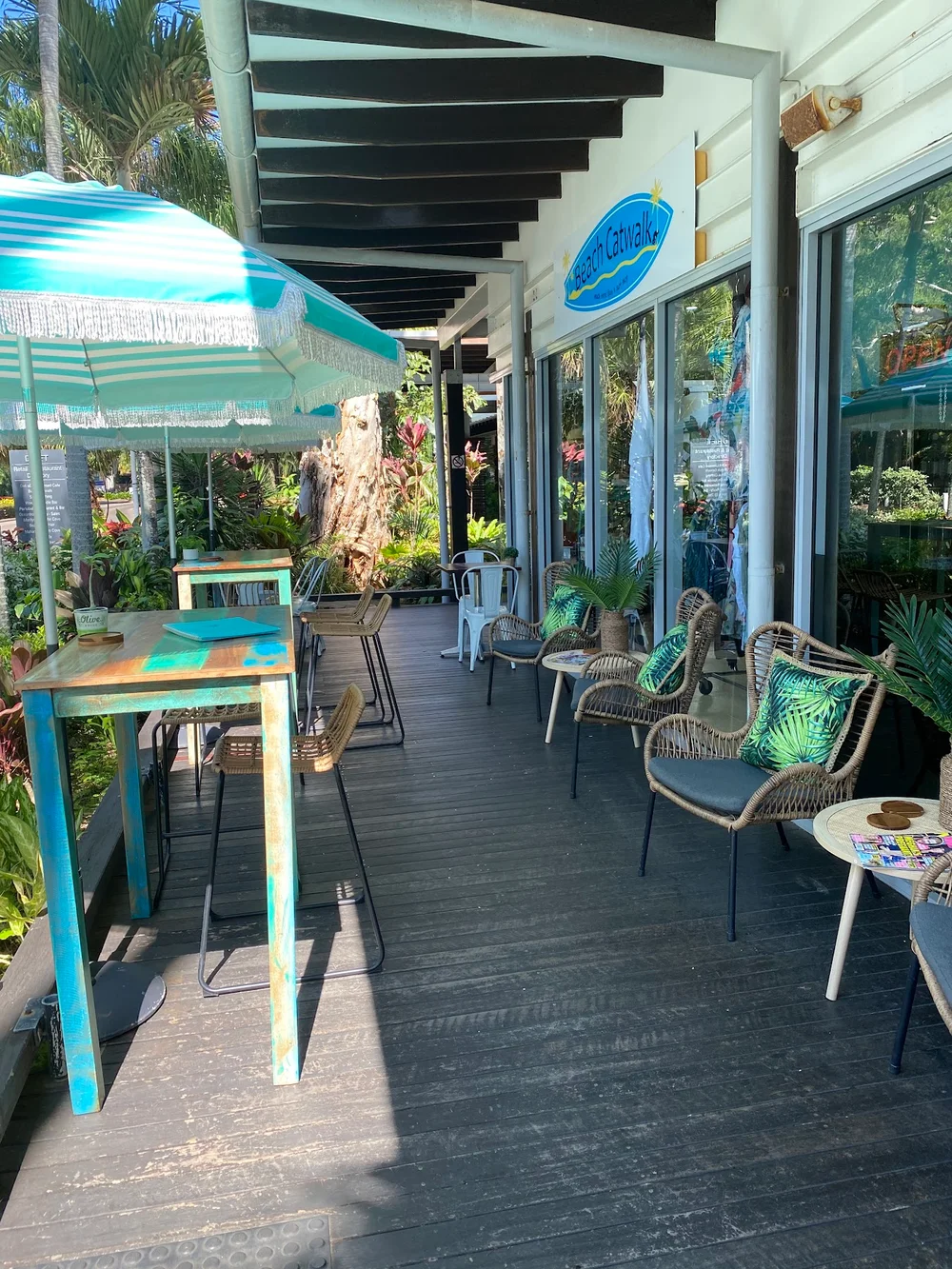The Beach Hut terrace with turquoise tables and tropical plants